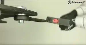 Ampco Safewrench non-sparking striking wrench being demonstrated with a hammer, emphasizing hands-free operation and enhanced safety for loosening or tightening large bolts in industrial applications.