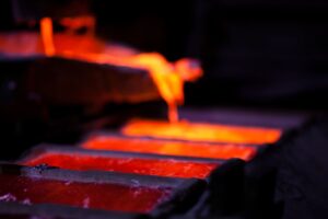Molten metal being poured in a foundry during the manufacturing process of high-quality, durable non-sparking safety tools, showcasing the robust production behind reliable safety equipment.